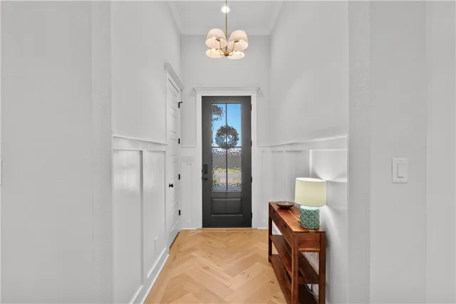 a bedroom with a bed and a chandelier