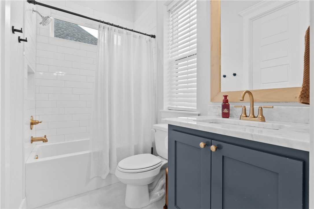 5001 Greenstone Way Bryan, TX 77802 - Photo 32 of 43 a bathroom with a sink a toilet and shower