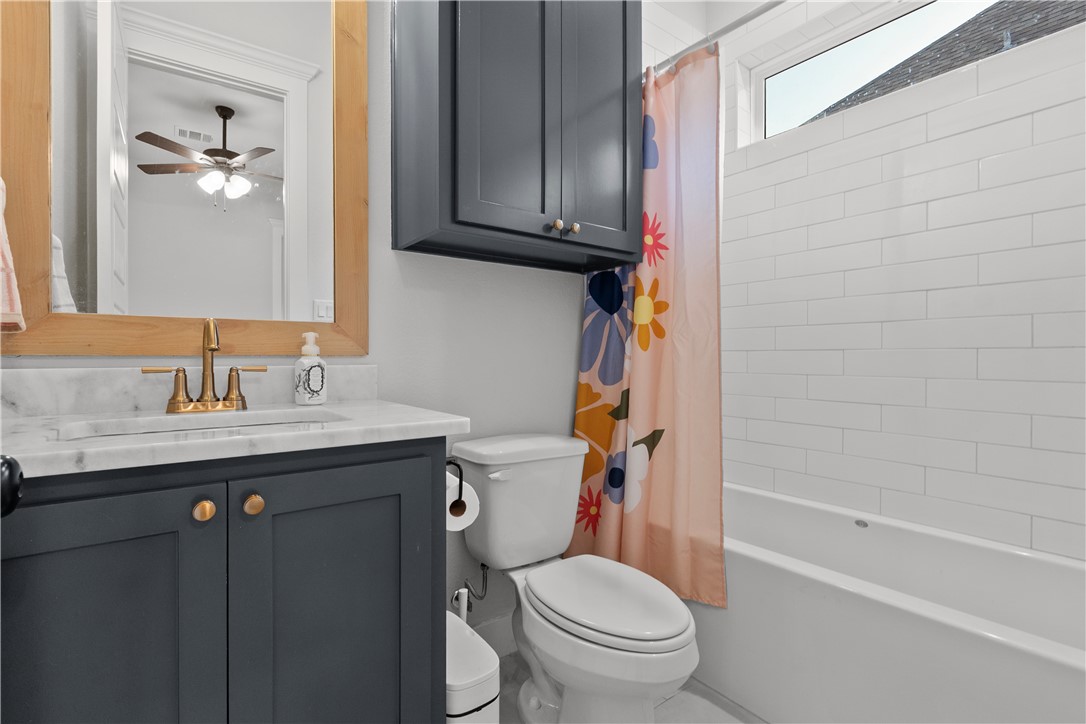 5001 Greenstone Way Bryan, TX 77802 - Photo 34 of 43 a bathroom with a granite countertop toilet sink and mirror