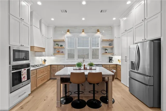 a kitchen with refrigerator cabinets dining table and chairs