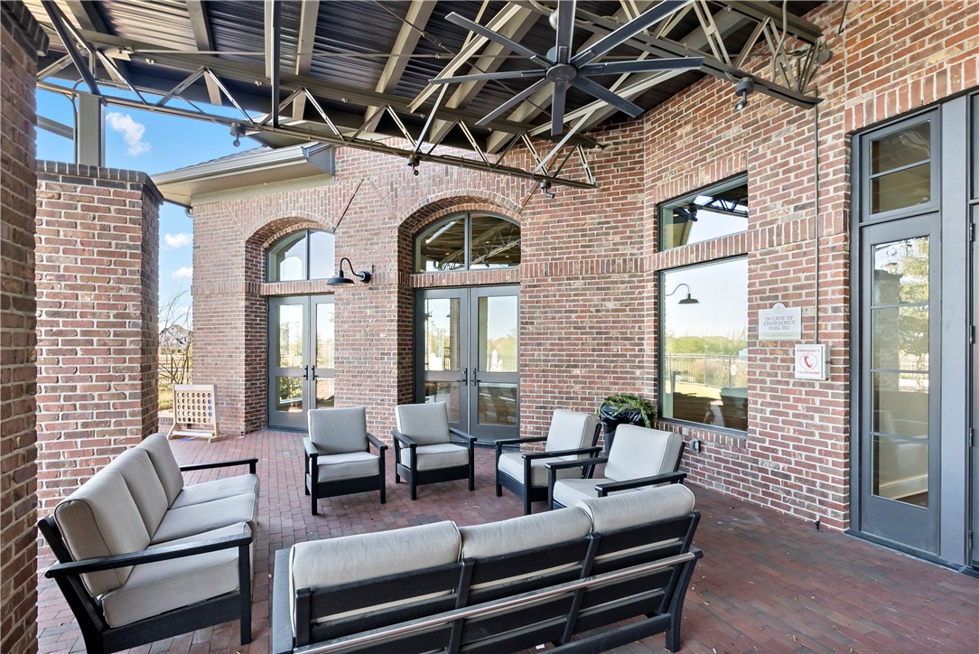5001 Greenstone Way Bryan, TX 77802 - Photo 40 of 43 a living room with furniture and a floor to ceiling window