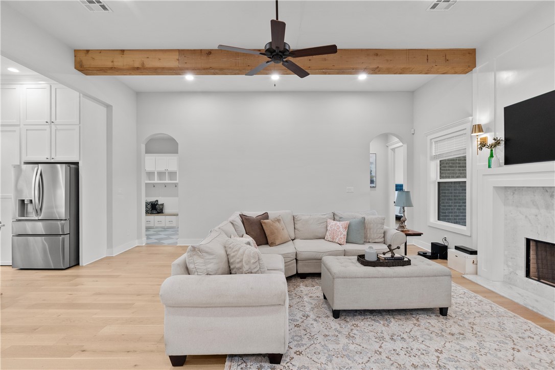 5001 Greenstone Way Bryan, TX 77802 - Photo 8 of 43 a living room with furniture a fireplace and a flat screen tv