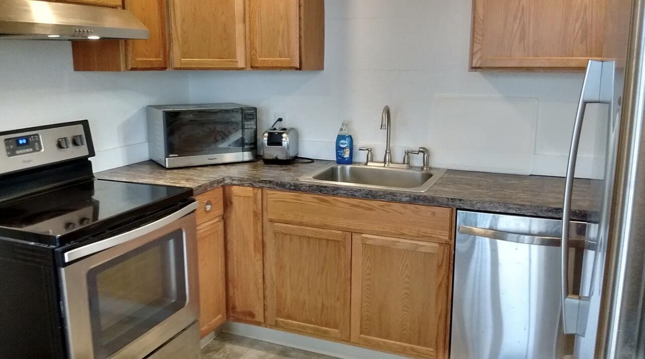 57655 Fall Road Christmas Valley, OR 97641 - Photo 5 of 25 a kitchen with granite countertop a sink stove and cabinets