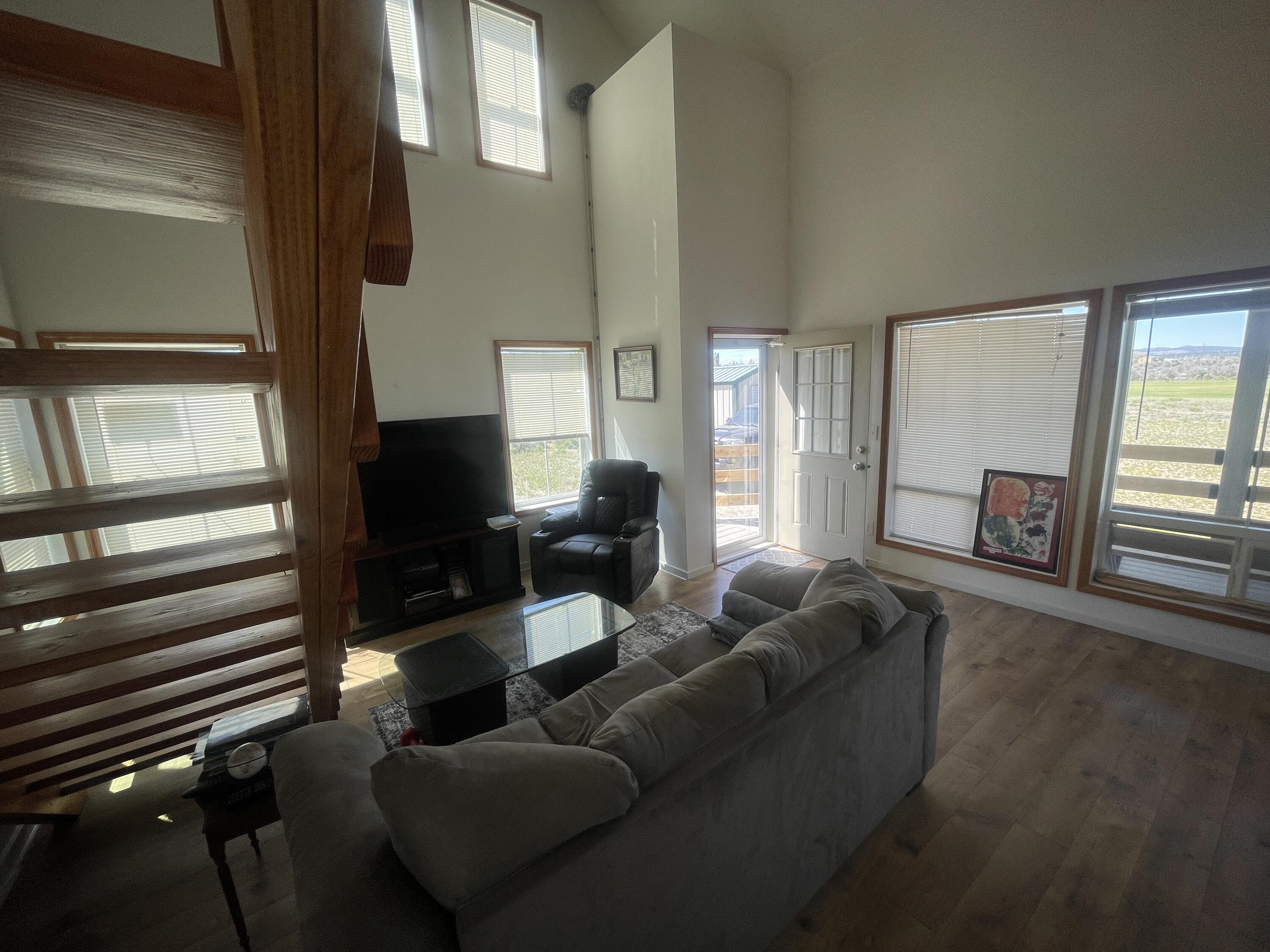 57655 Fall Road Christmas Valley, OR 97641 - Photo 9 of 25 a living room with furniture and a flat screen tv