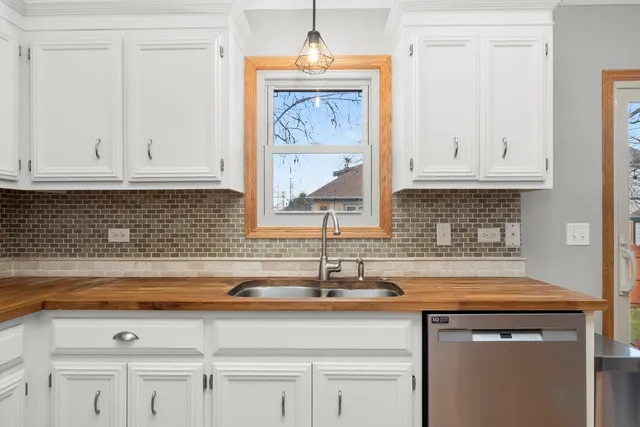 a kitchen with white cabinets and a sink