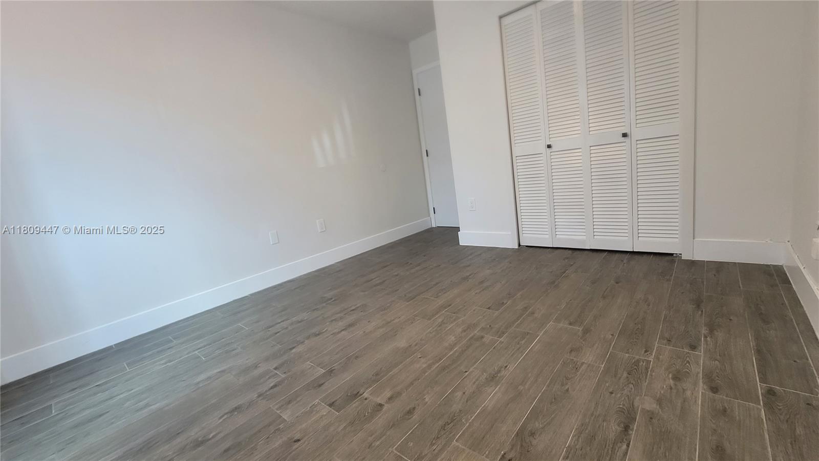 14641 Southwest 52nd Street Miami, FL 33175 - Photo 16 of 26 a view of an empty room with wooden floor