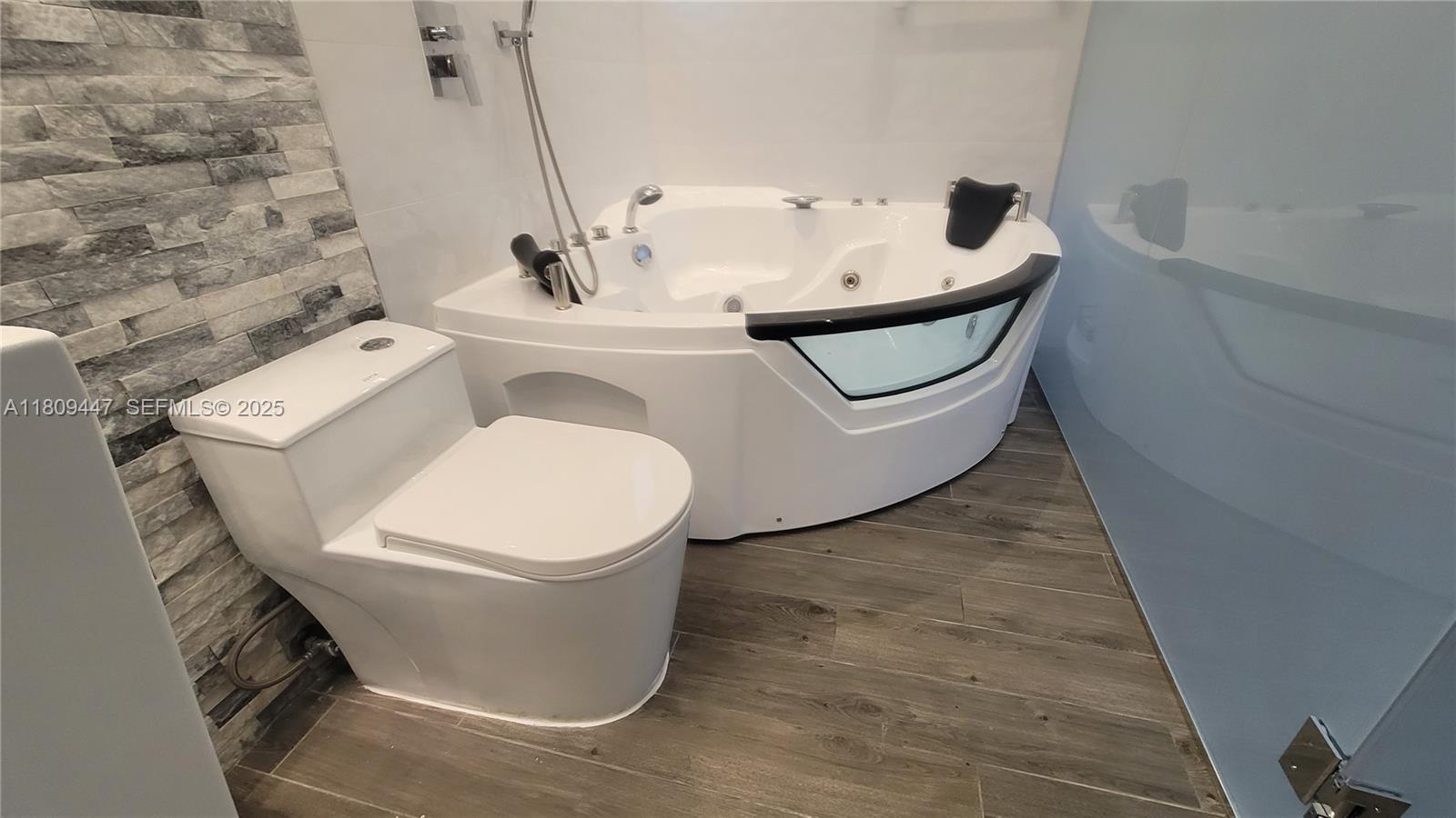 14641 Southwest 52nd Street Miami, FL 33175 - Photo 17 of 26 a bathroom with a sink and mirror with toilet