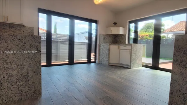 a view of a kitchen with a sink and a window