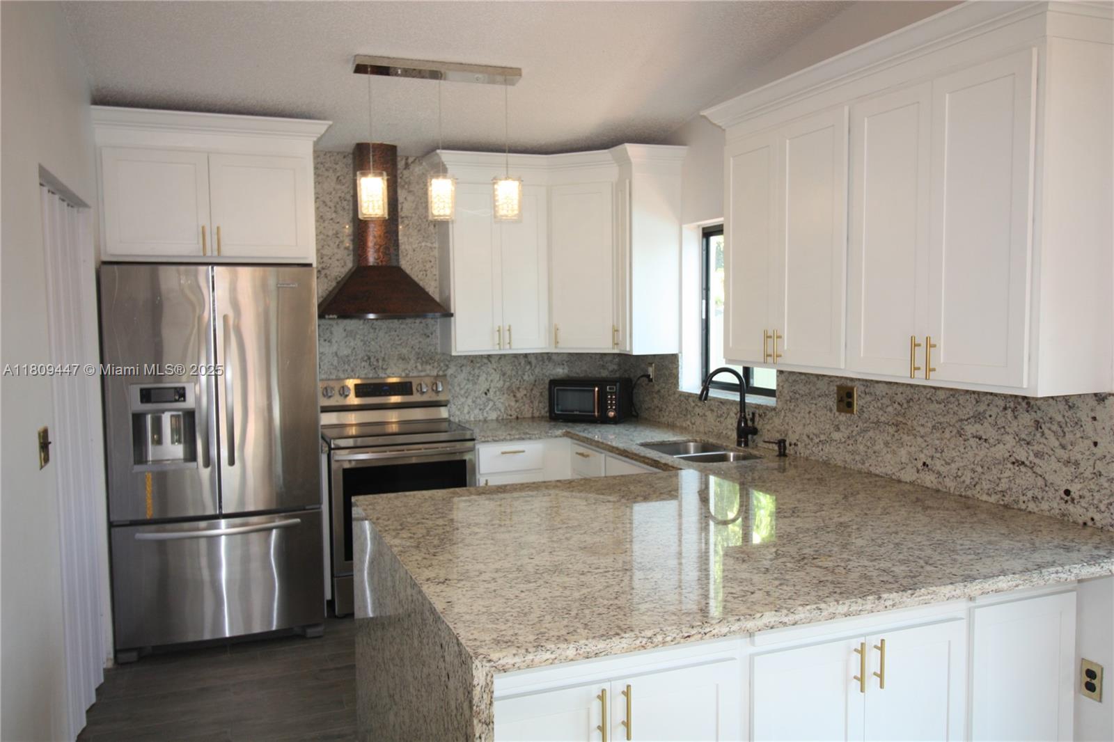 14641 Southwest 52nd Street Miami, FL 33175 - Photo 22 of 26 a kitchen with stainless steel appliances granite countertop a sink stove and refrigerator