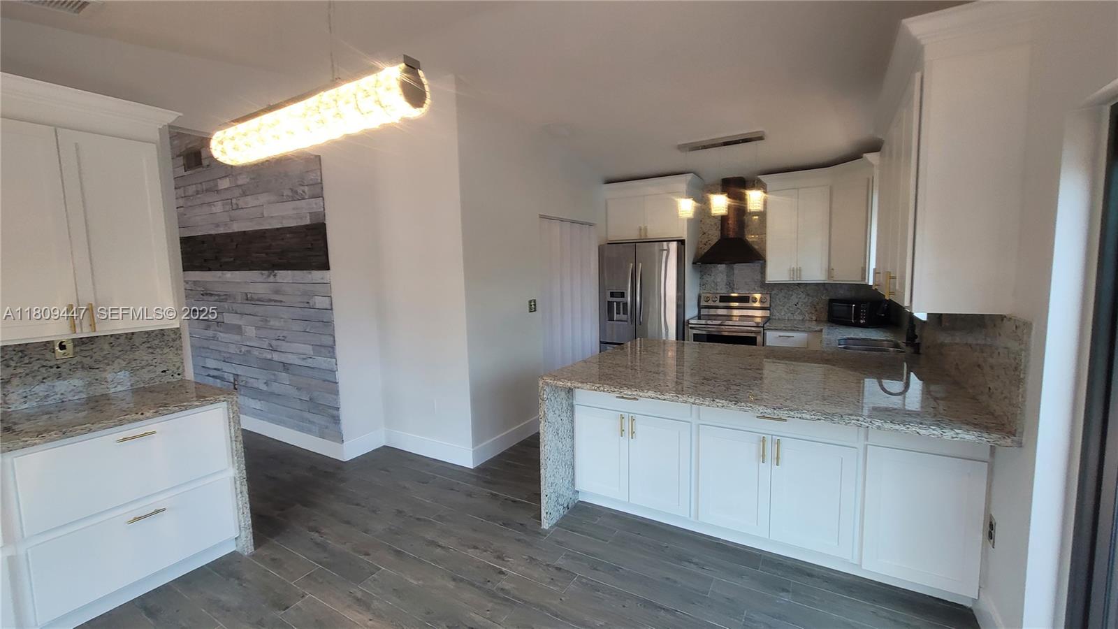 14641 Southwest 52nd Street Miami, FL 33175 - Photo 23 of 26 a bathroom with a granite countertop sink and a mirror
