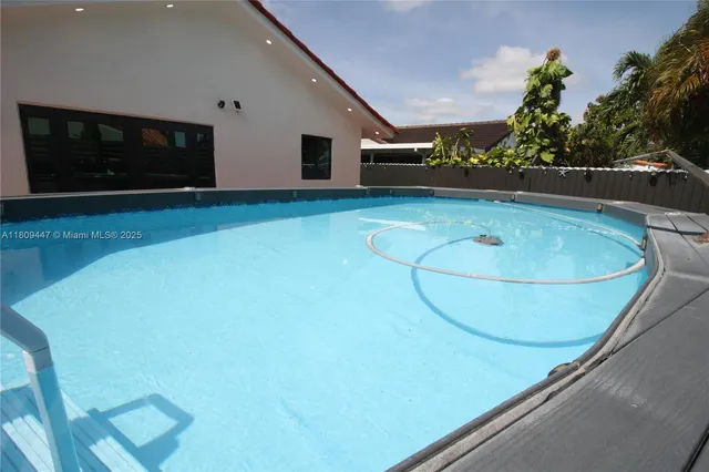 a room with wooden floor and pool table