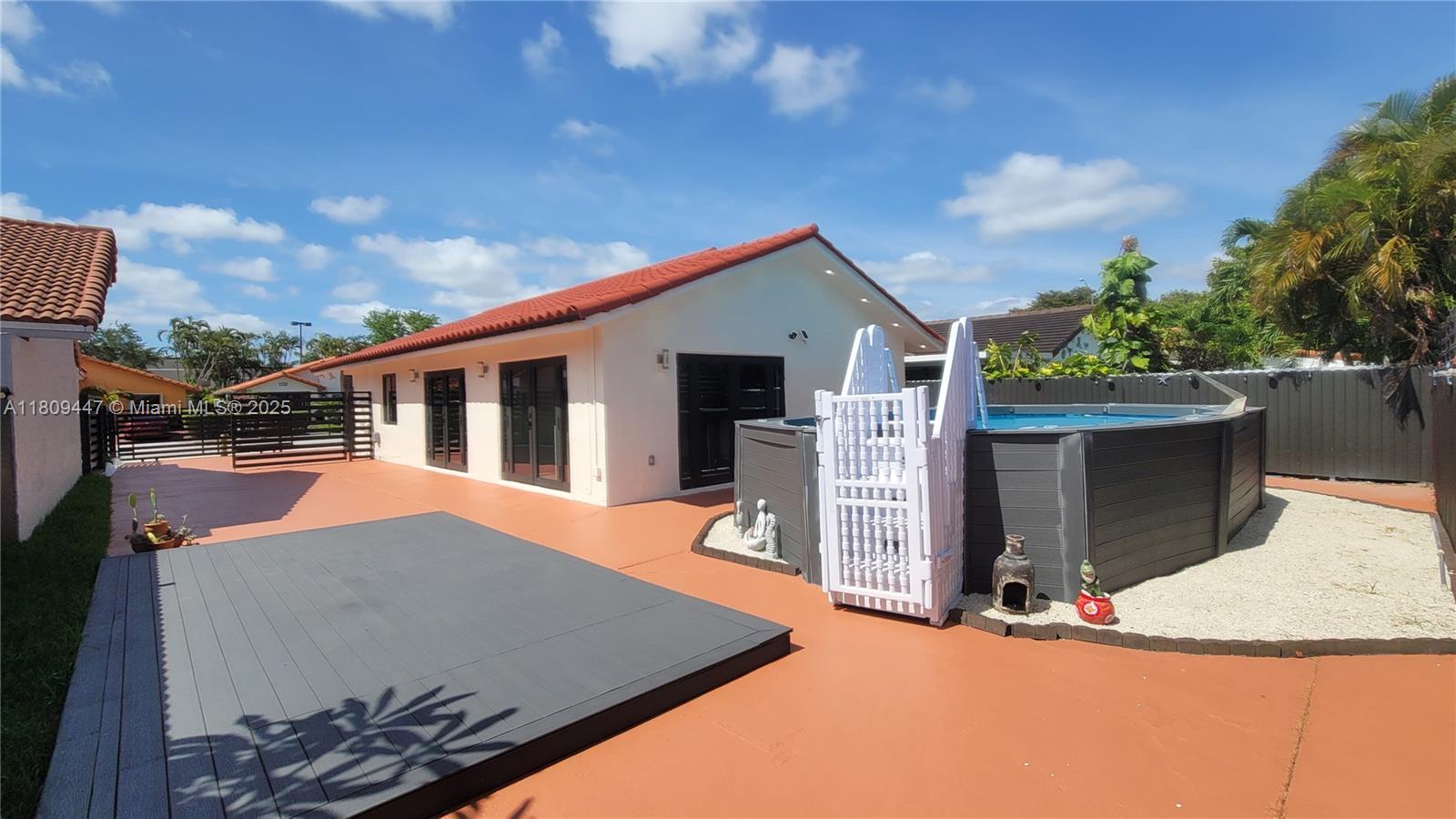 14641 Southwest 52nd Street Miami, FL 33175 - Photo 5 of 26 a backyard of a house with seating space