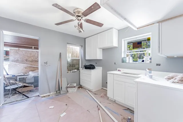a view of a kitchen with a sink and cabinet with wooden floor