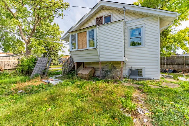 a backyard of a house with table and chairs