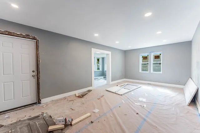 a bedroom with a large bed and a window