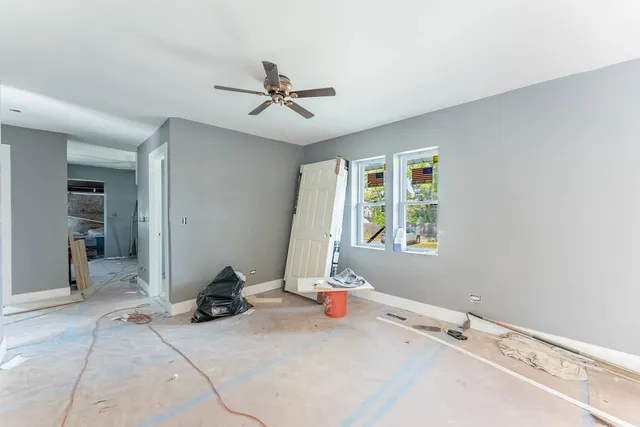 a room with a window and a ceiling fan