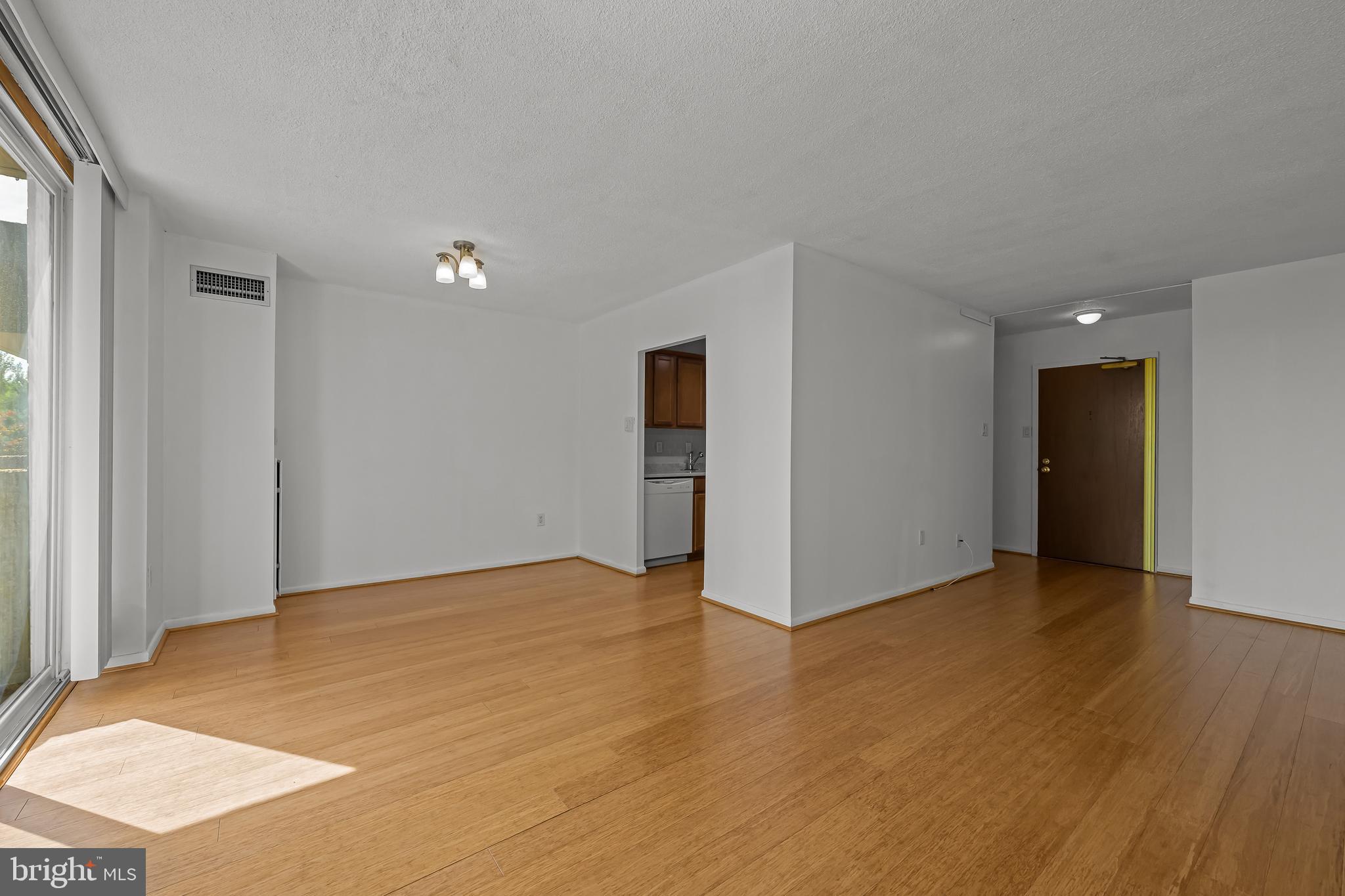 2016 Naamans Road, Unit 5E Wilmington, DE 19810 - Photo 11 of 24 a view of an empty room with wooden floor and a window