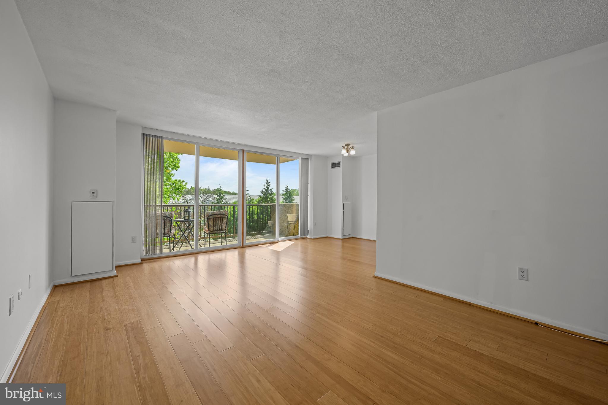 2016 Naamans Road, Unit 5E Wilmington, DE 19810 - Photo 14 of 24 a view of an empty room with wooden floor and a window