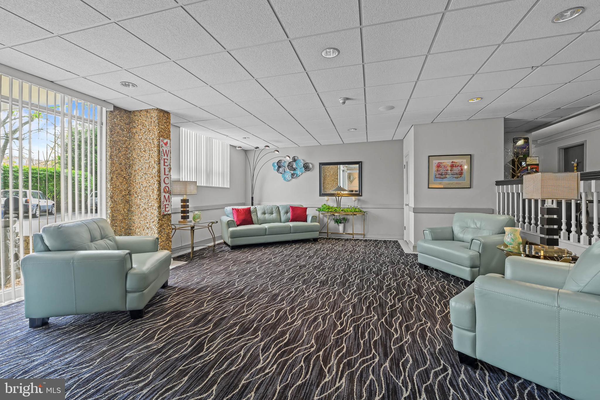 2016 Naamans Road, Unit 5E Wilmington, DE 19810 - Photo 4 of 24 a living room with furniture and a table