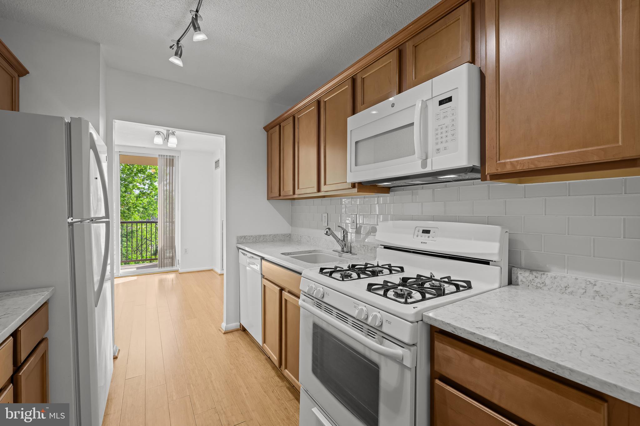 2016 Naamans Road, Unit 5E Wilmington, DE 19810 - Photo 9 of 24 a kitchen with stainless steel appliances granite countertop a stove a refrigerator and a microwave