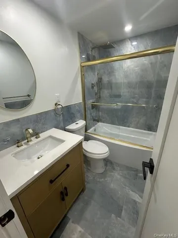 a bathroom with a sink mirror vanity and toilet