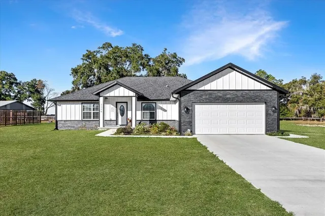 a front view of a house with a yard and porch