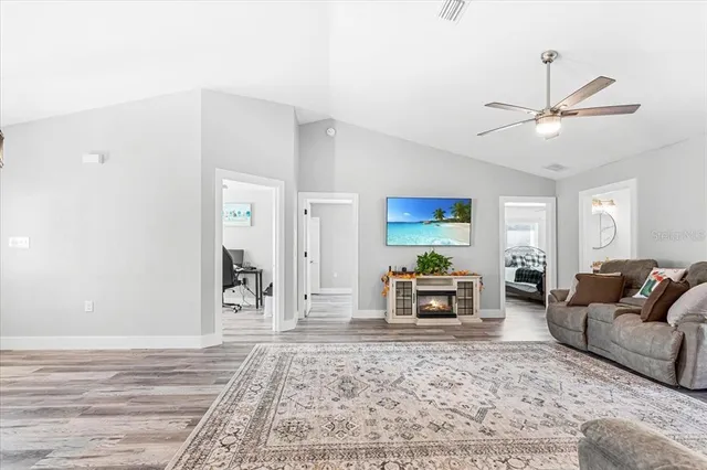 a living room with furniture and a wooden floor