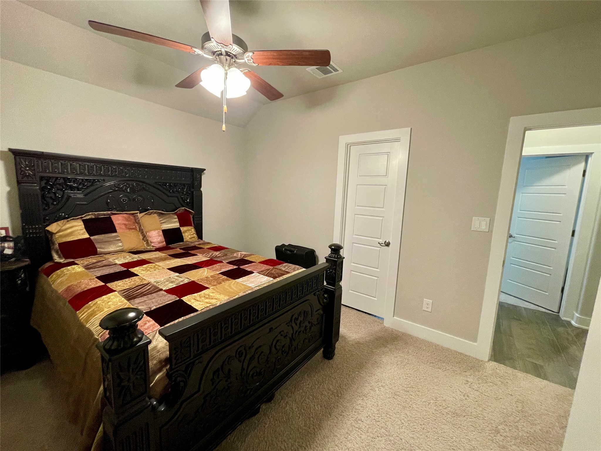 120 Sail Wind Way Georgetown, TX 78633 - Photo 18 of 25 a bedroom with a bed and a chandelier