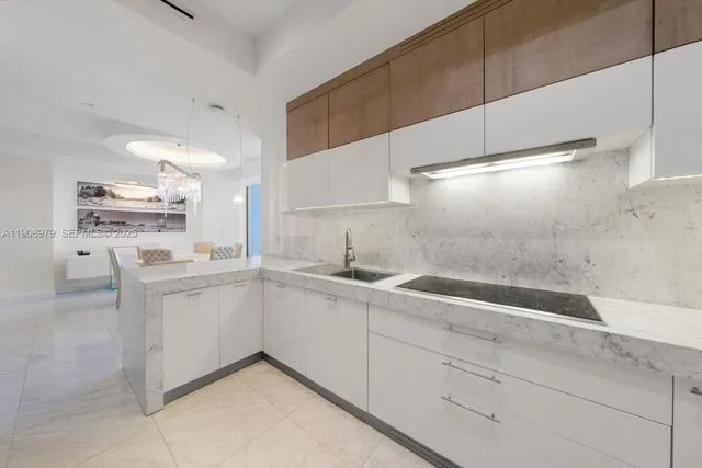 a bathroom with a sink toilet vanity and shower