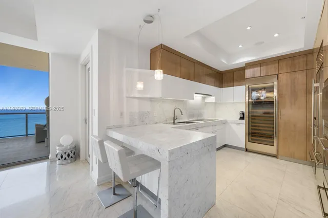 a kitchen with appliances cabinets and furniture