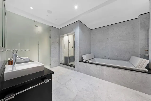 a spacious bathroom with a double vanity sink a toilet and a mirror