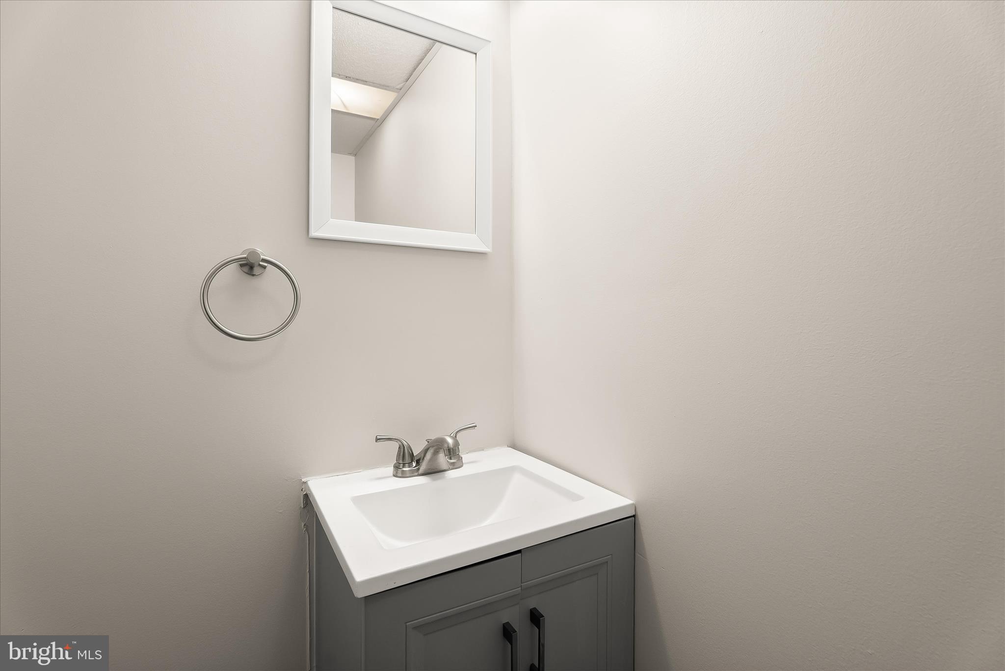 5810 Ritchie Street Glen Burnie, MD 21061 - Photo 37 of 55 a bathroom with a sink and a mirror