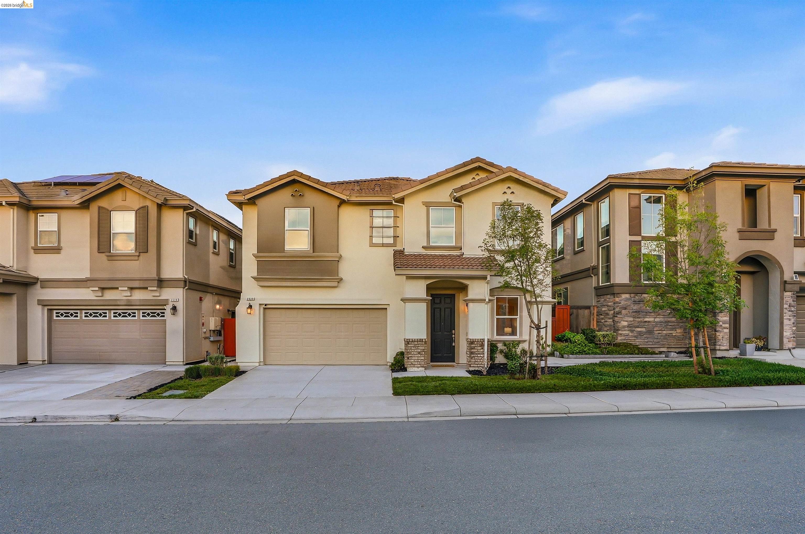 2525 Modena Drive Pittsburg, CA 94565 - Photo 1 of 34 a front view of a house with a yard and garage