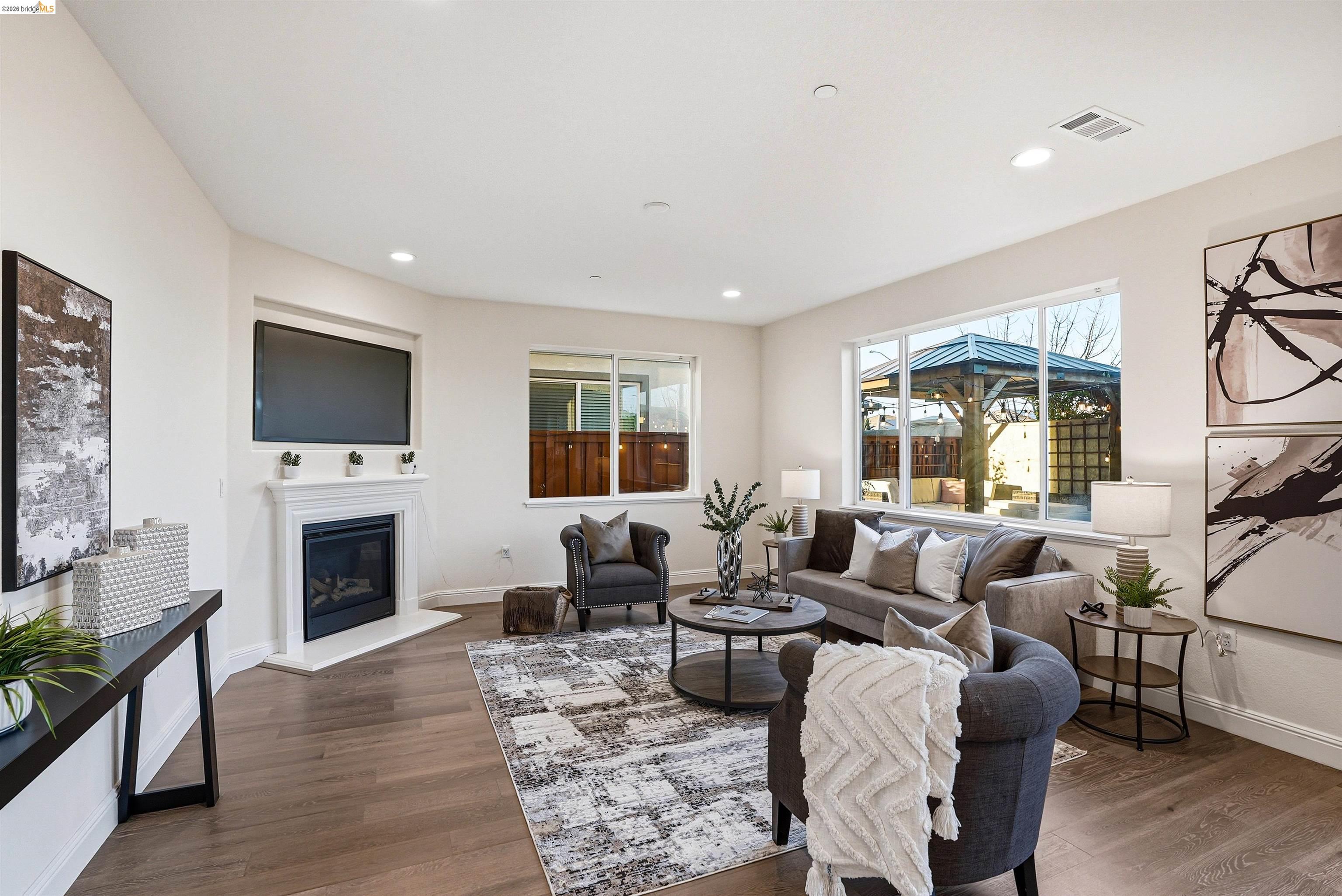 2525 Modena Drive Pittsburg, CA 94565 - Photo 5 of 34 a living room with furniture a flat screen tv and a fireplace