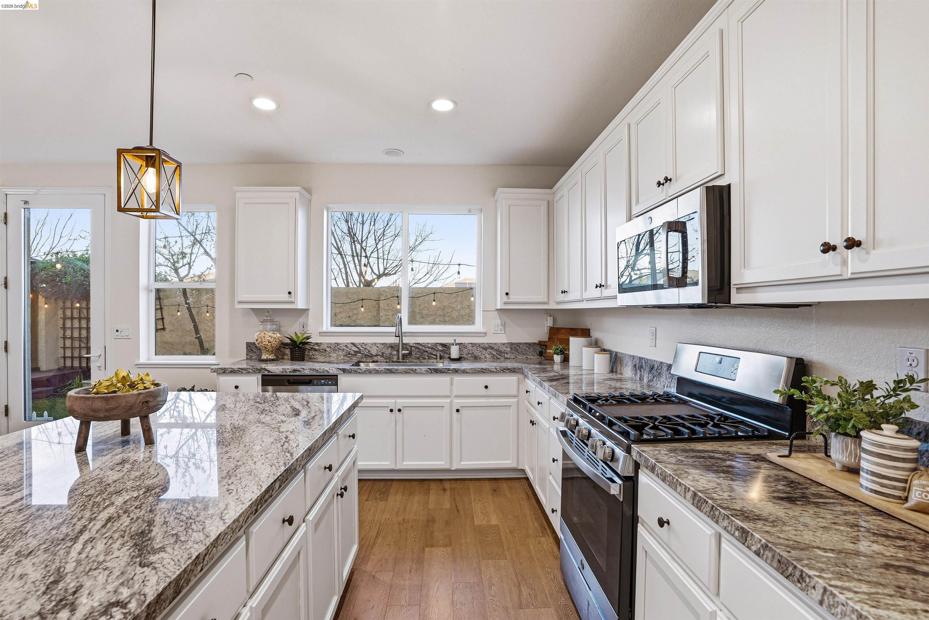 2525 Modena Drive Pittsburg, CA 94565 - Photo 8 of 34 a kitchen with stainless steel appliances granite countertop a stove and a sink