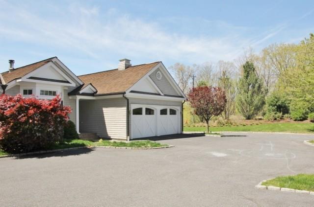 306 Danbury Road, Unit 4 Wilton, CT 06897 - Photo 1 of 1 a view of a house with a garden and pathway