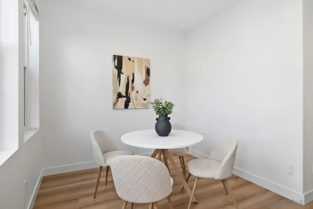 a dining room with furniture and wooden floor