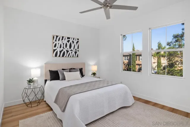 a bedroom with a bed and a painting on the wall