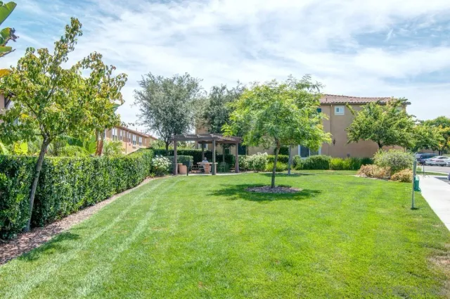 a garden with trees in the background