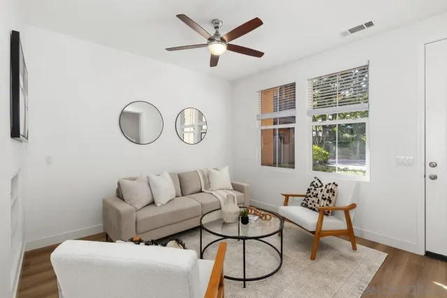 a living room with furniture a table and a window