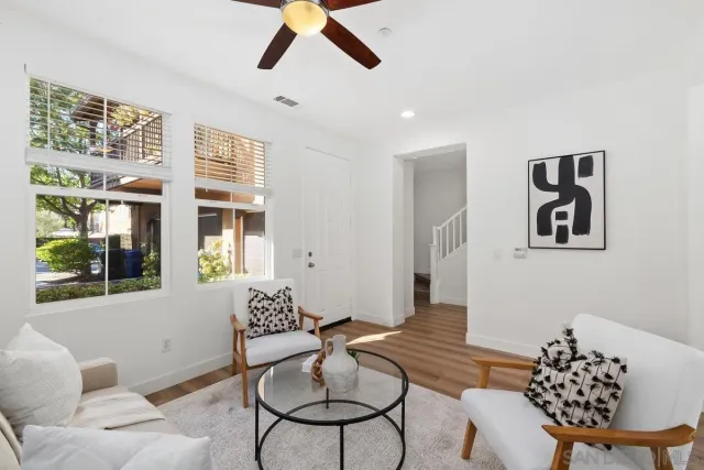 a living room with furniture and a large window