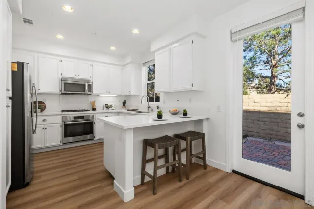 a kitchen with a stove a sink and a refrigerator