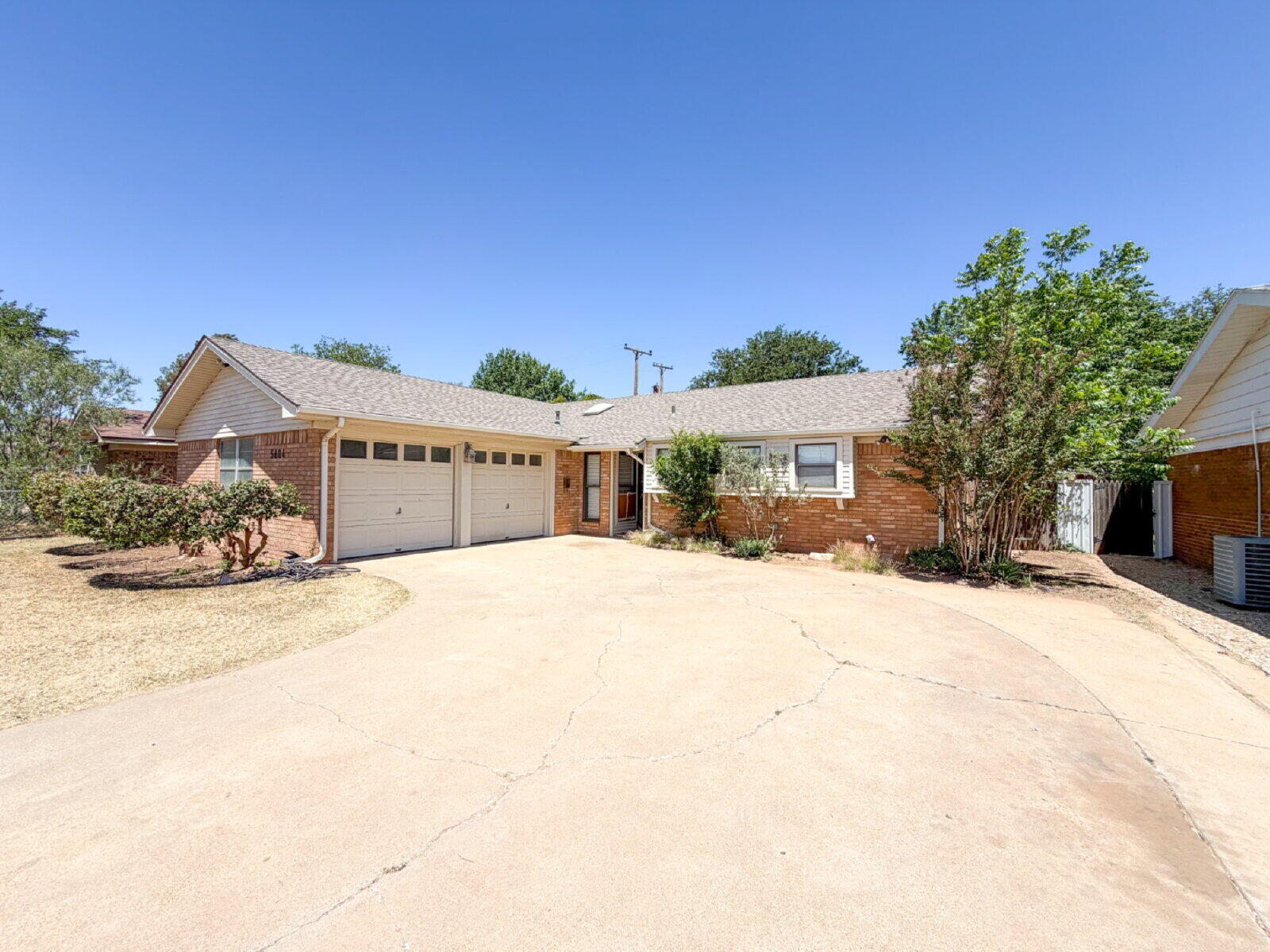 5604 38th Street Lubbock, TX 79407 - Photo 1 of 11 a front view of a house with a yard and garage