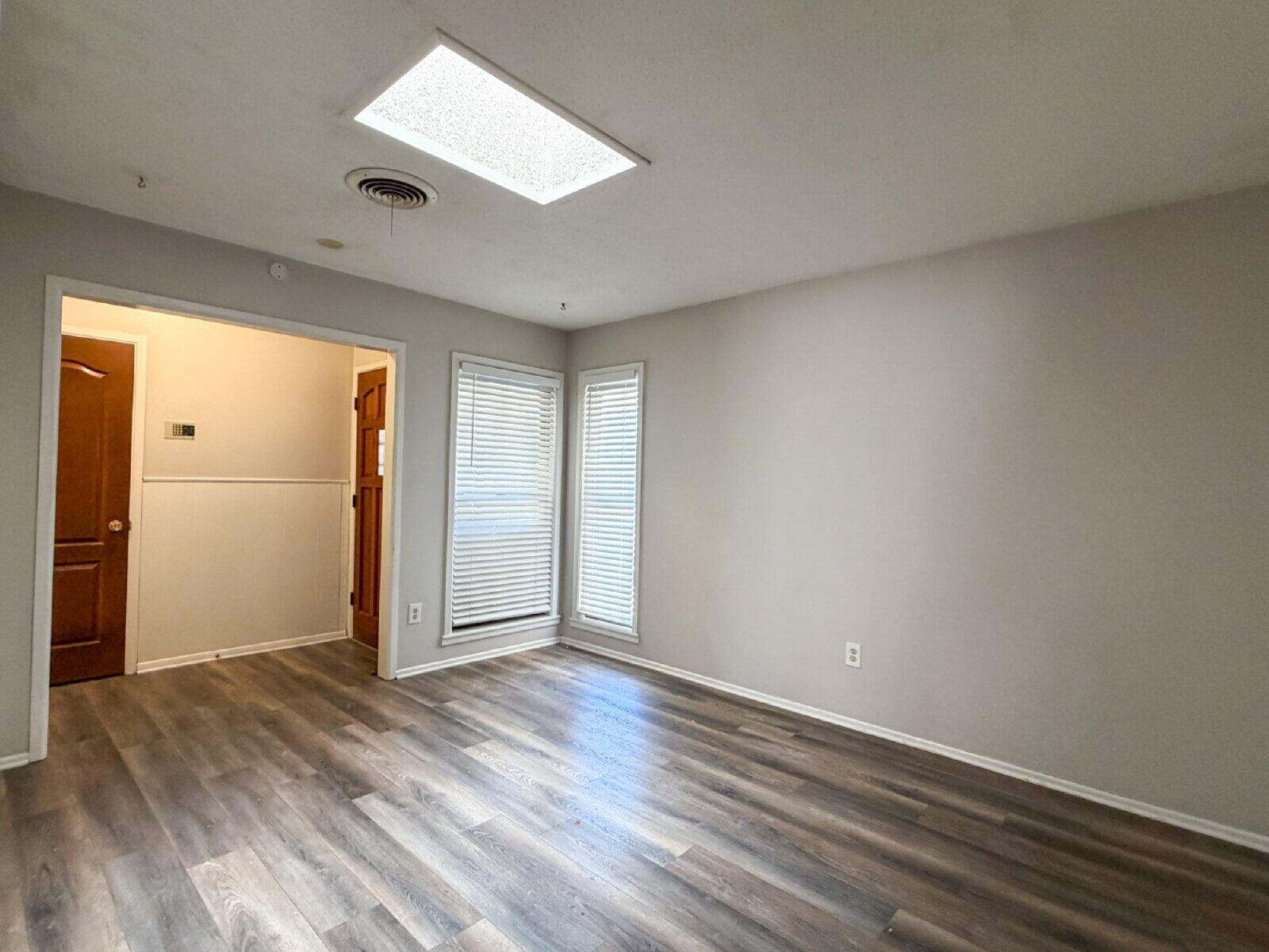 5604 38th Street Lubbock, TX 79407 - Photo 3 of 11 an empty room with wooden floor and windows