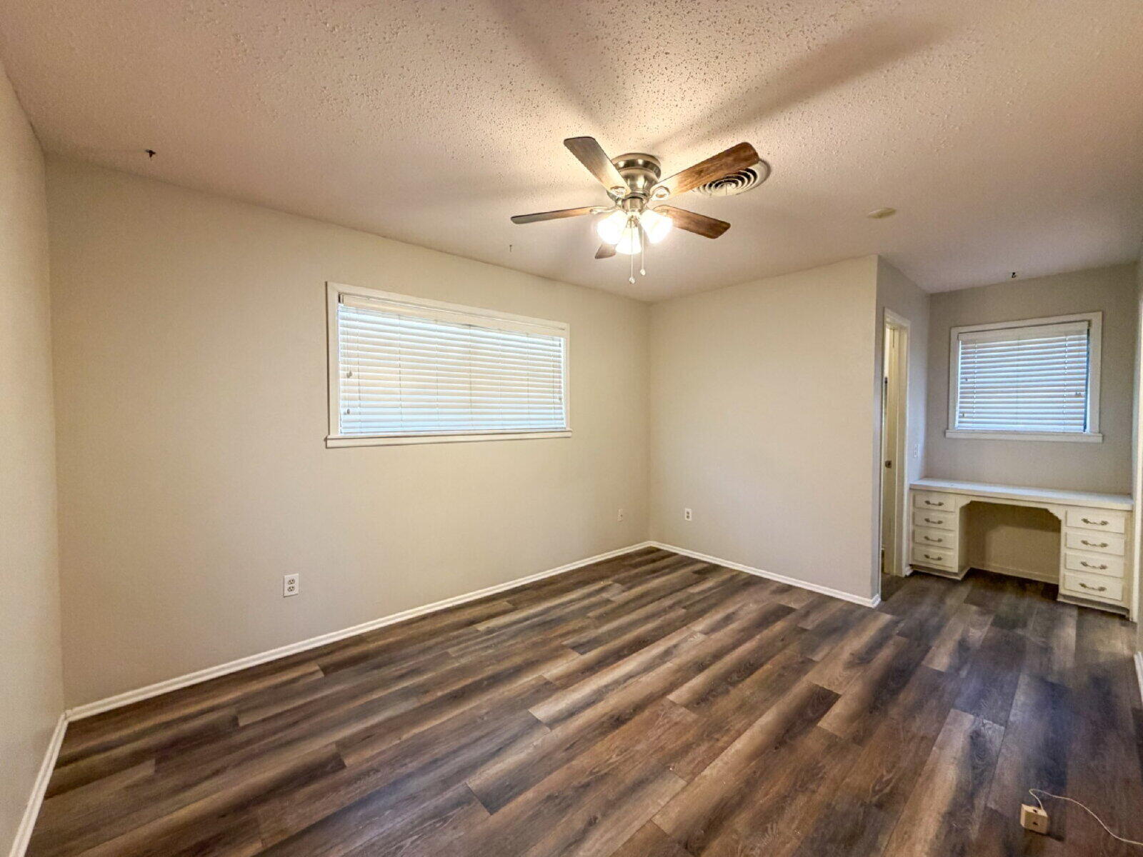 5604 38th Street Lubbock, TX 79407 - Photo 7 of 11 a view of empty room with wooden floor and fan