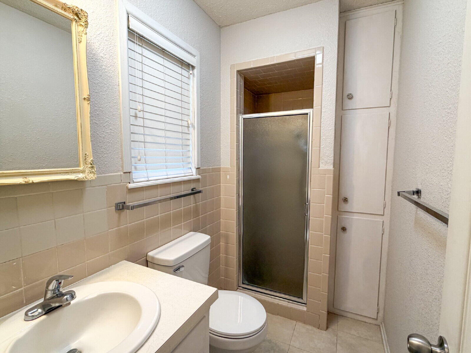 5604 38th Street Lubbock, TX 79407 - Photo 8 of 11 a bathroom with a sink a toilet and shower