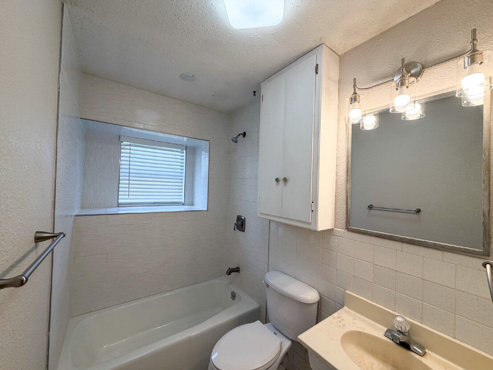 5604 38th Street Lubbock, TX 79407 - Photo 10 of 11 a bathroom with a granite countertop bathtub shower sink vanity and toilet