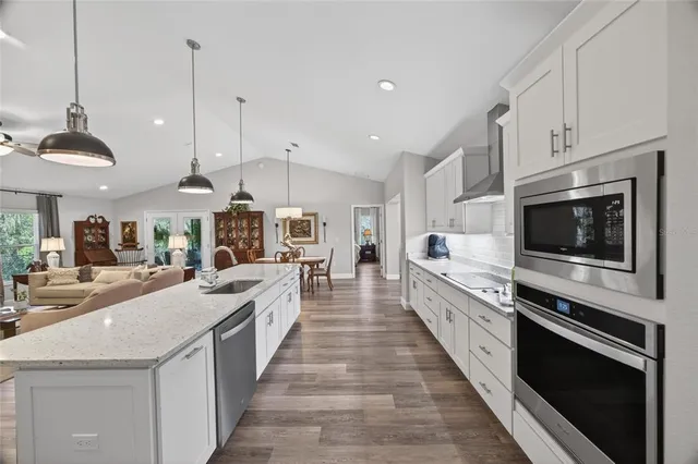 a kitchen with white cabinets and white appliances