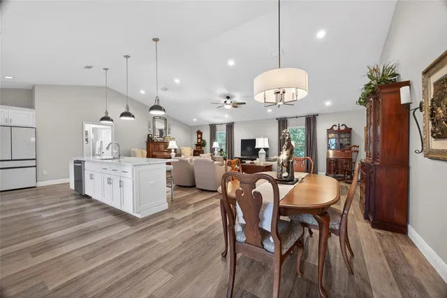 a living room with furniture a flat screen tv and kitchen view