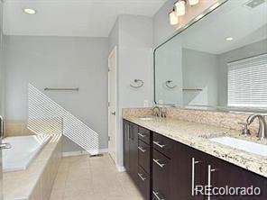 244 South Monroe Street Denver, CO 80209 - Photo 13 of 16 a bathroom with a granite countertop sink and a large mirror